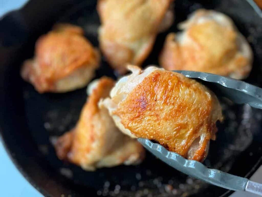 Image shows yummy cast iron chicken thighs.