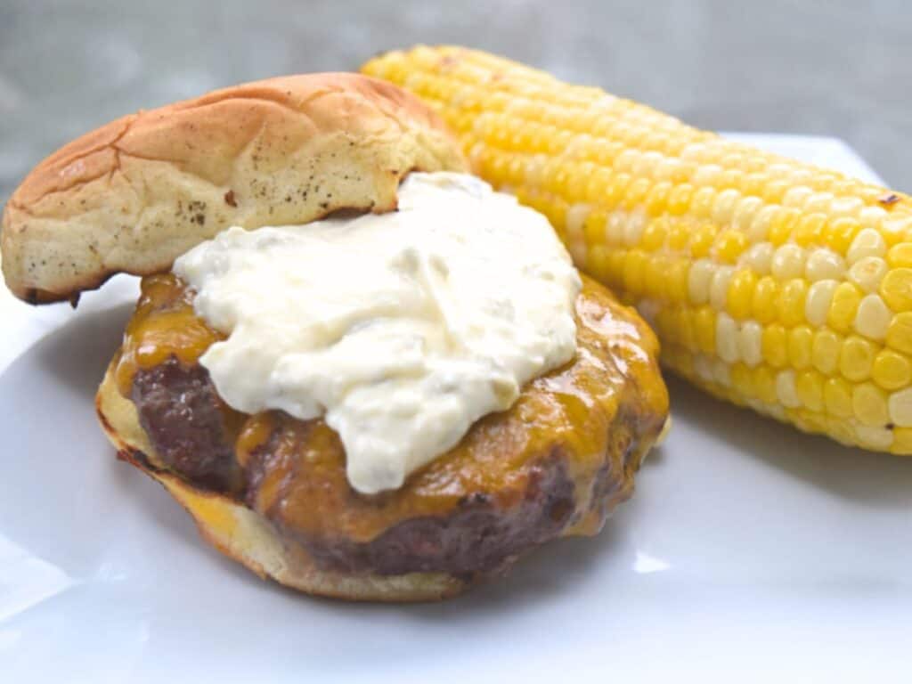 Image shows yummy chipotle burger with jalapeno mayo.