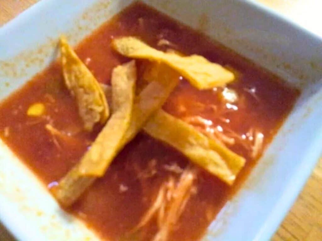 Image shows yummy homemade tortilla soup in a bowl.
