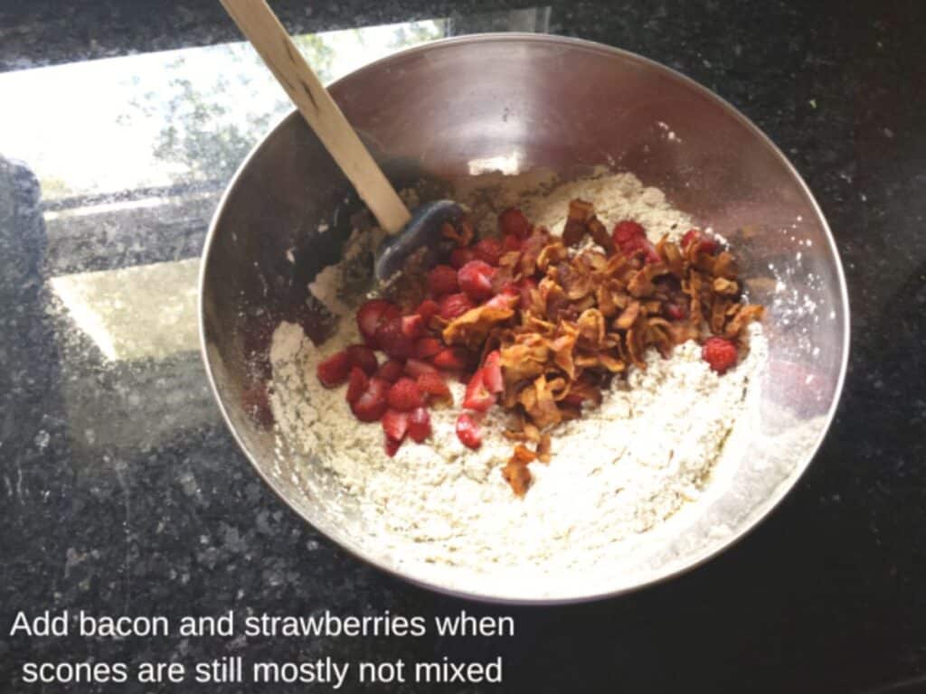 Image shows adding bacon and strawberries to scone dough.