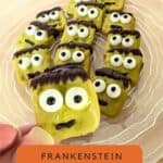 Image shows a Closeup of a hand holding a decorated pretzel with text Frankenstein Pretzels Easy Halloween Treat.