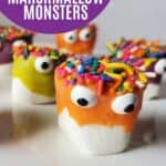 Image shows a Closeup of decorated marshmallows with text easy and cute Halloween Treat Monster Marshmallows.