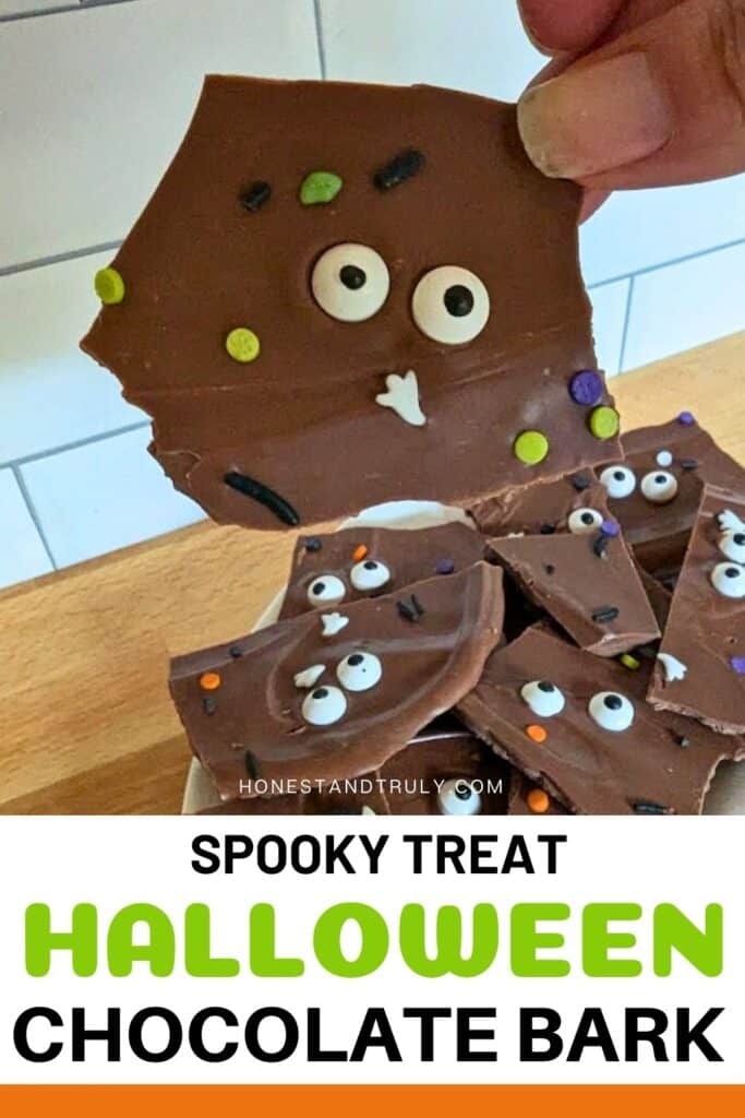 Image shows a Closeup of hand with chocolate and text spooky treat halloween chocolate bark.