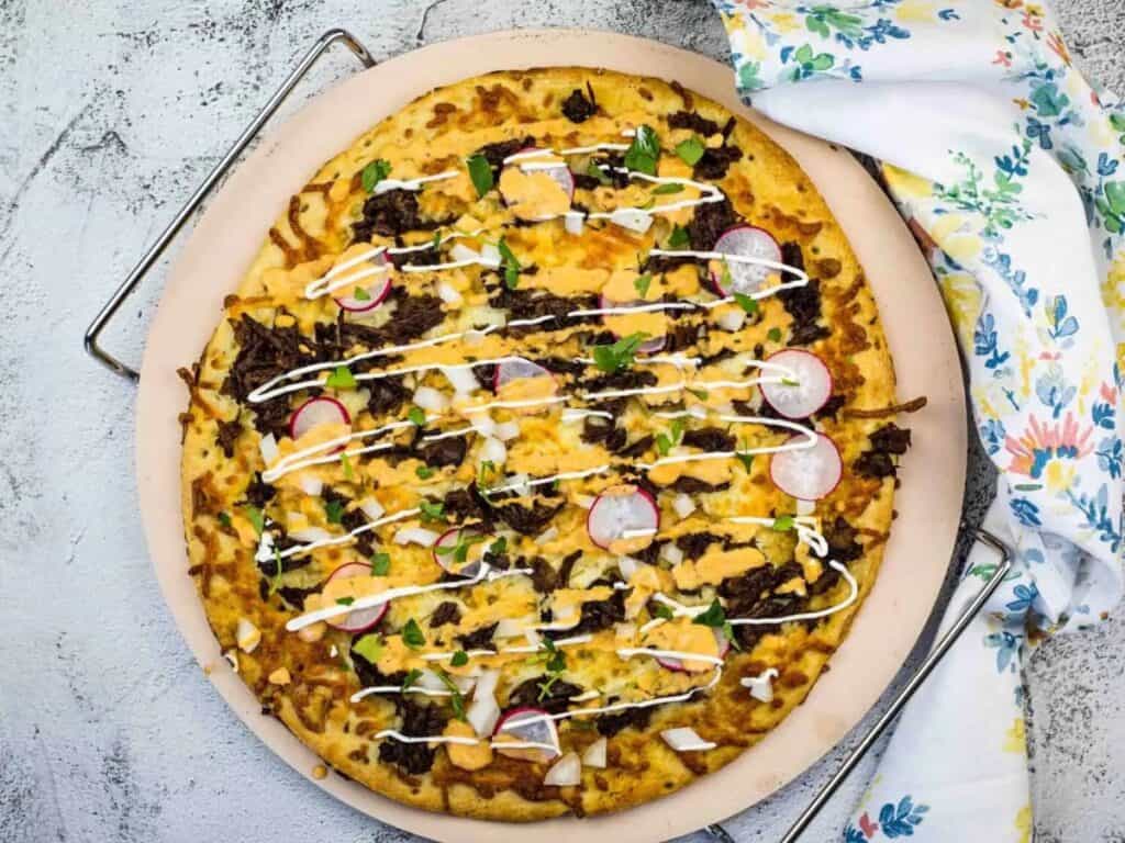 Image shows delicious birria pizza.