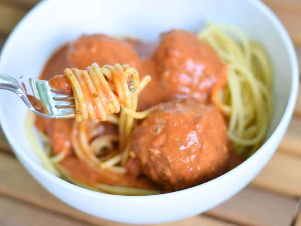 Image shows delicious meatballs and sauce.