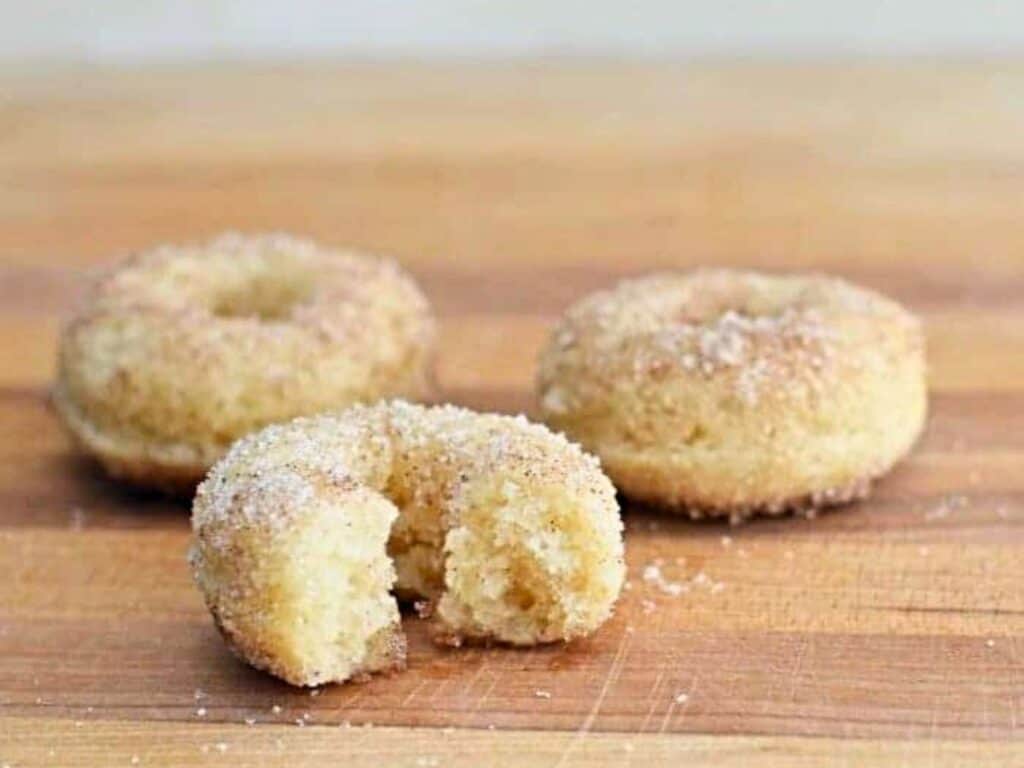 Image shows easy to make homemade cinnamon sugar donuts.