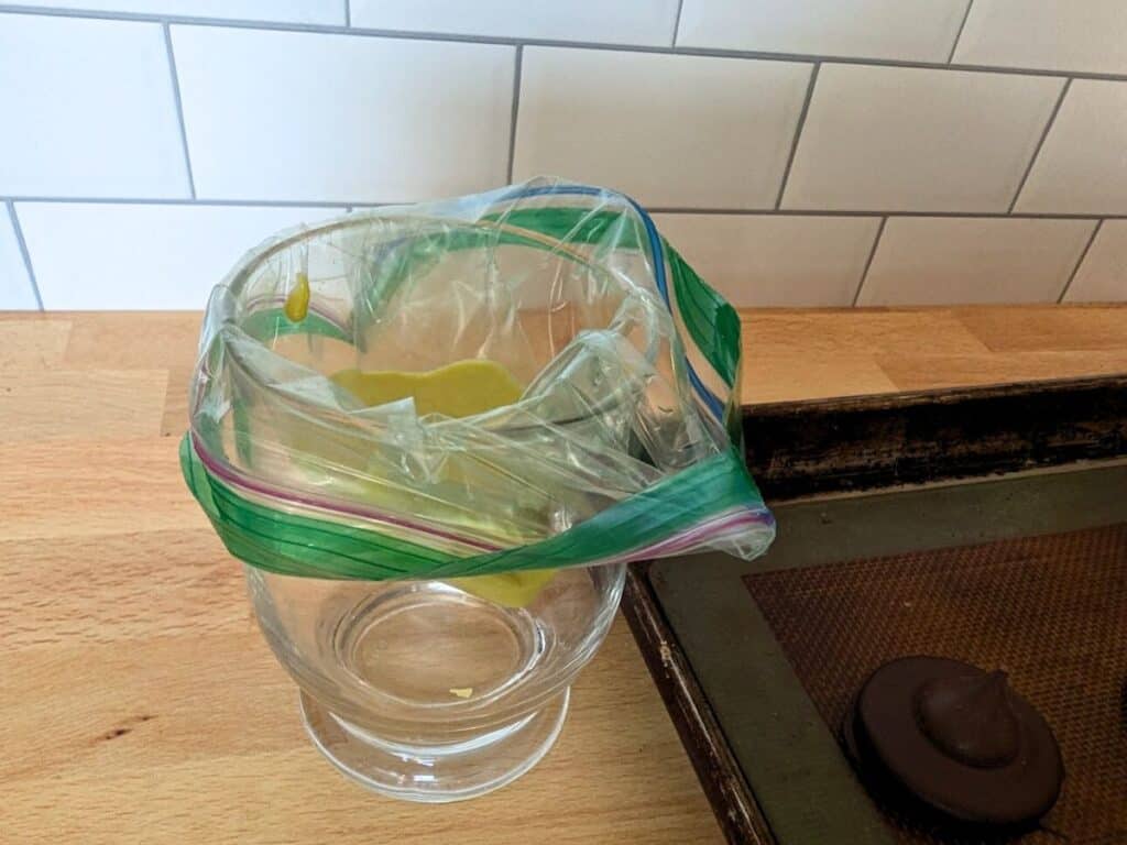 Image shows Green chocolate in a bag inside a glass.