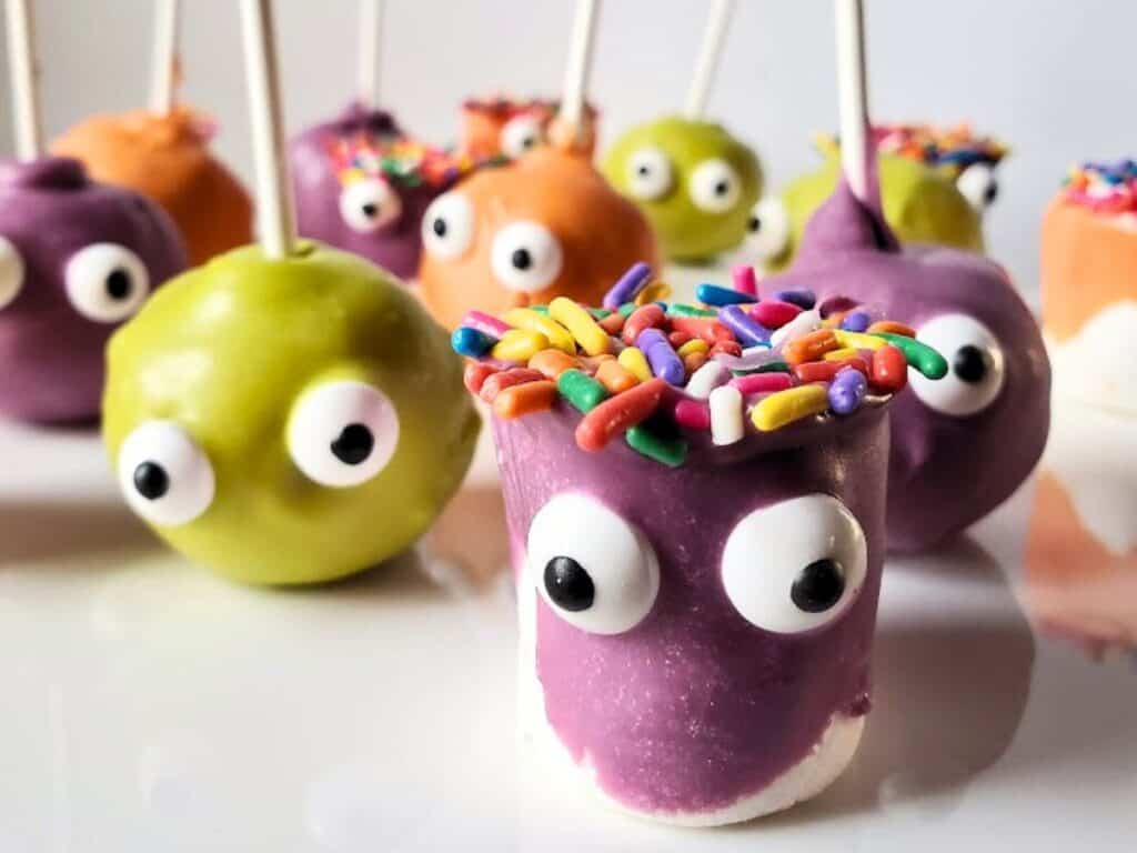 Image shows Monster marshmallows and cake pops on a white platter.