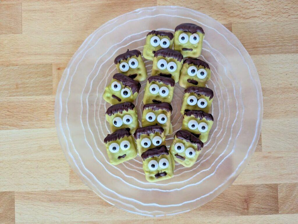 Image shows an Overhead of a plate of Halloween Frankenstein pretzels.