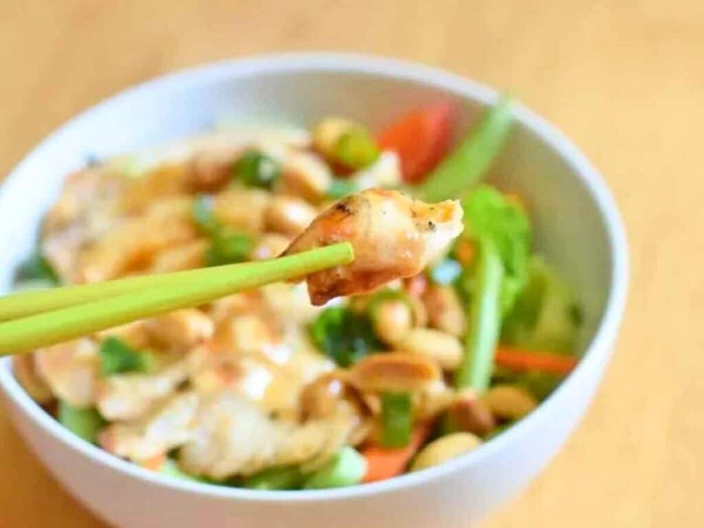 Image shows bite of irresistible kung pao chicken salad.