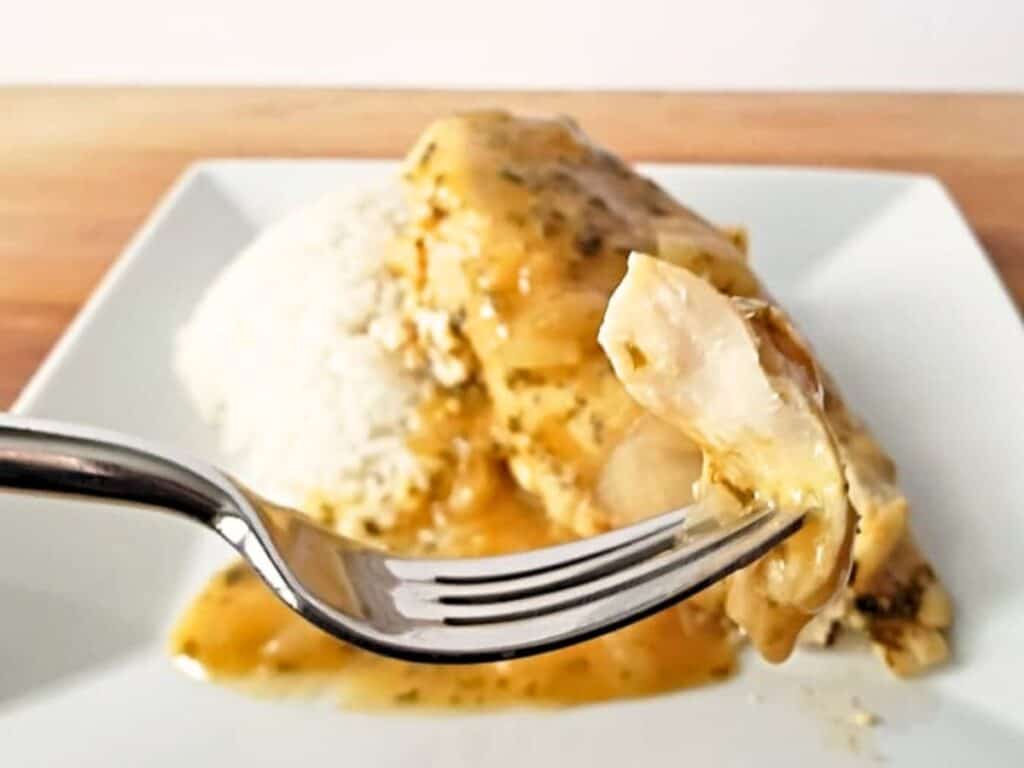 Image shows bite of yummy lemon garlic chicken.