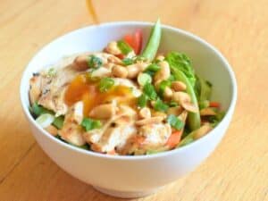 Image shows bowl of delicious kung pao chicken salad.