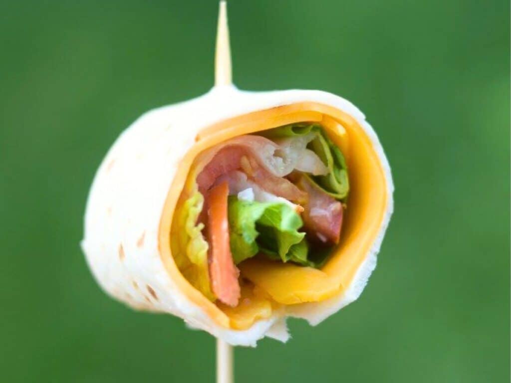 Image shows delicious chicken taco wrap in a pinwheel form.