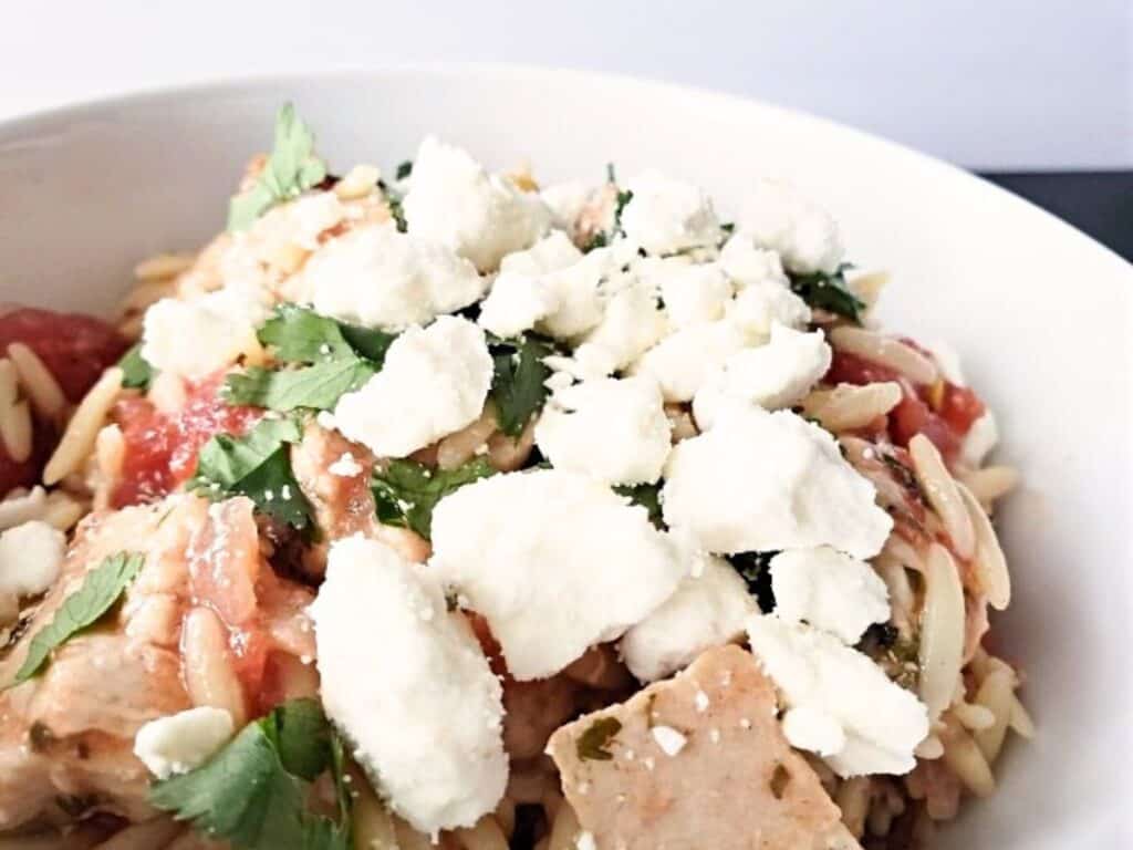 Image shows easy to make Mediterranean chicken orzo.