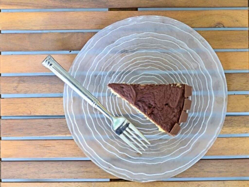 Image shows irresistible kit kat cake on a plate.