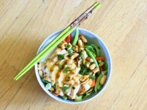 Image shows bowl of delicious and homemade kung pao chicken salad.