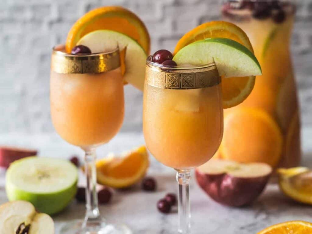 Image shows easy to make orange cranberry sangria mocktail.
