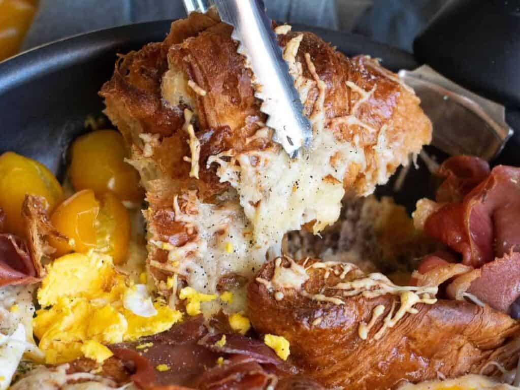 Image shows irresistible croissant breakfast casserole.