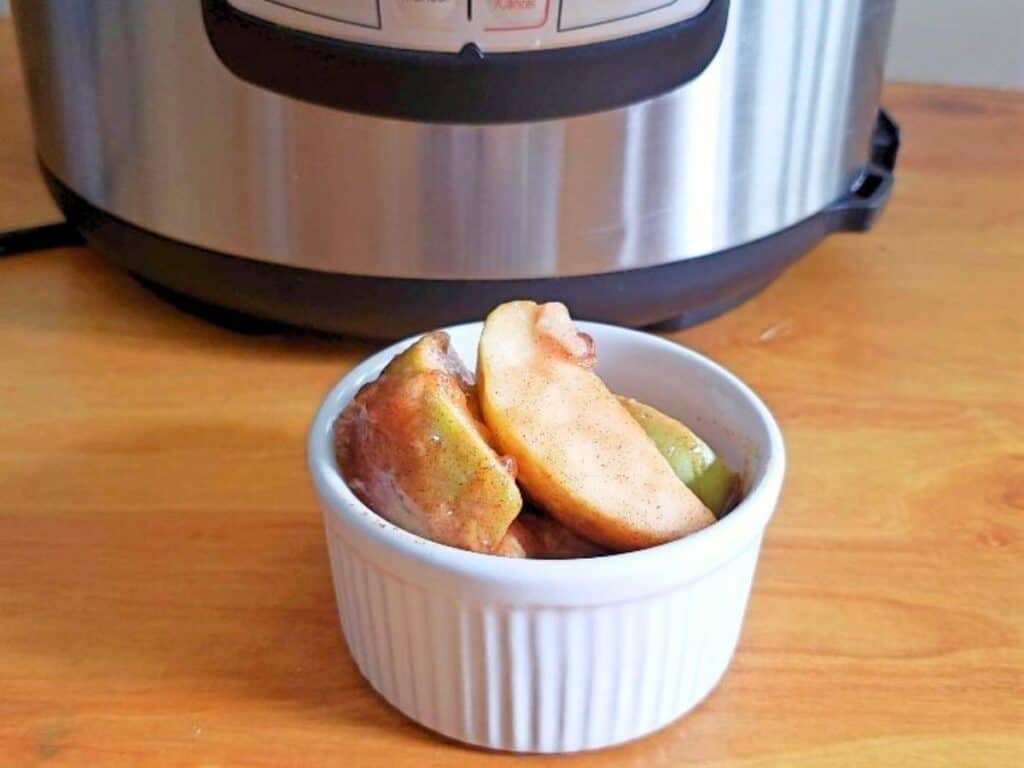 Image shows yummy instant pot cinnamon apples in a bowl.