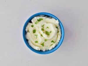 Image shows yummy mashed potatoes in a bowl.