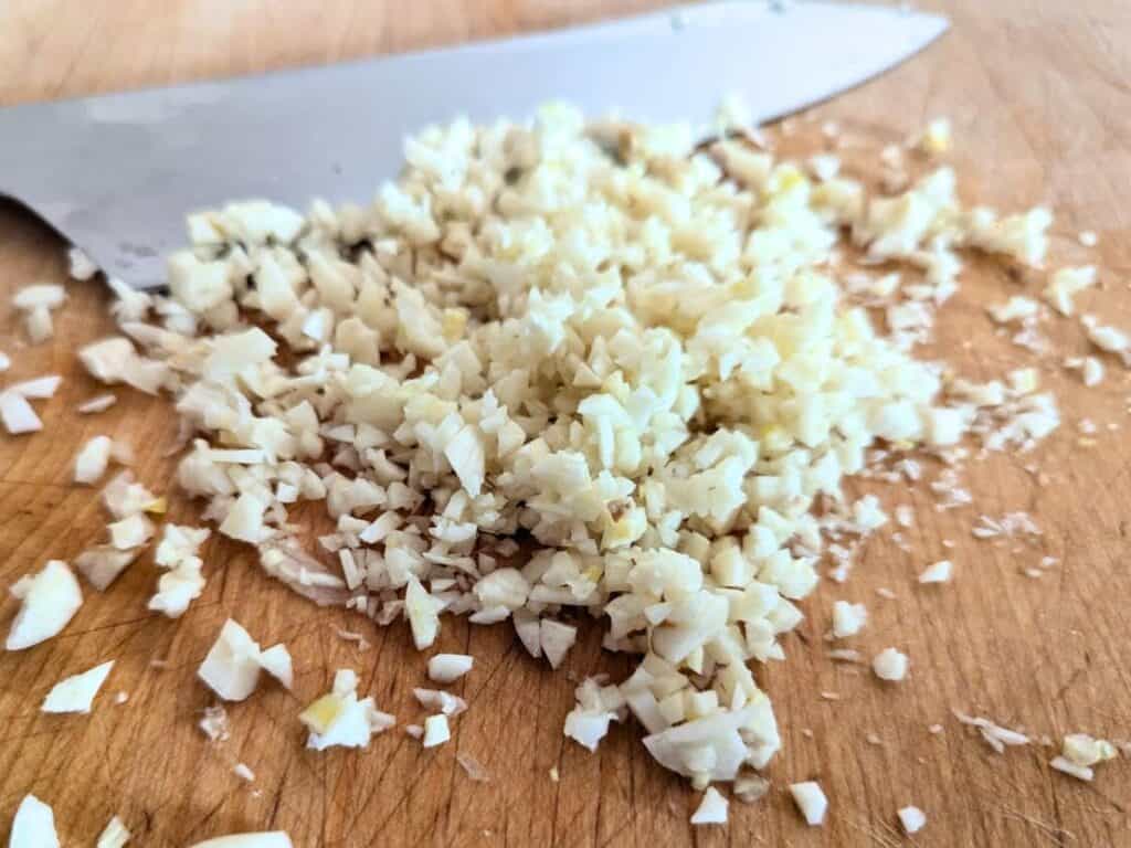 Image shows garlic minced into small pieces.