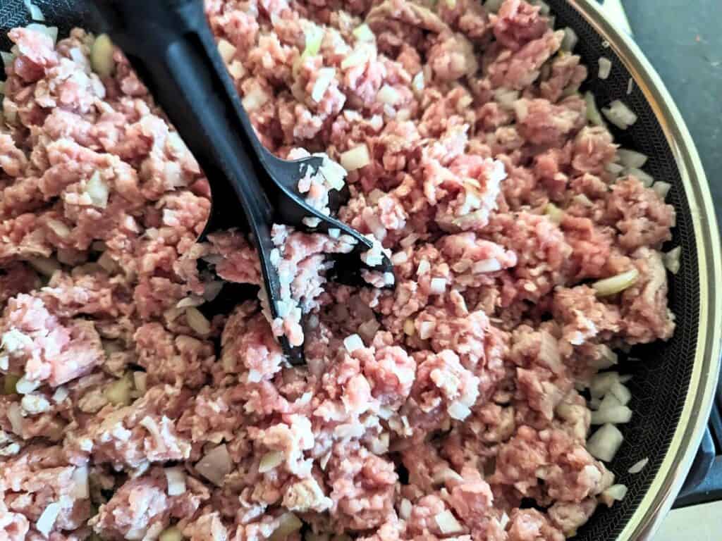 Image shows ground pork cooked on skillet.