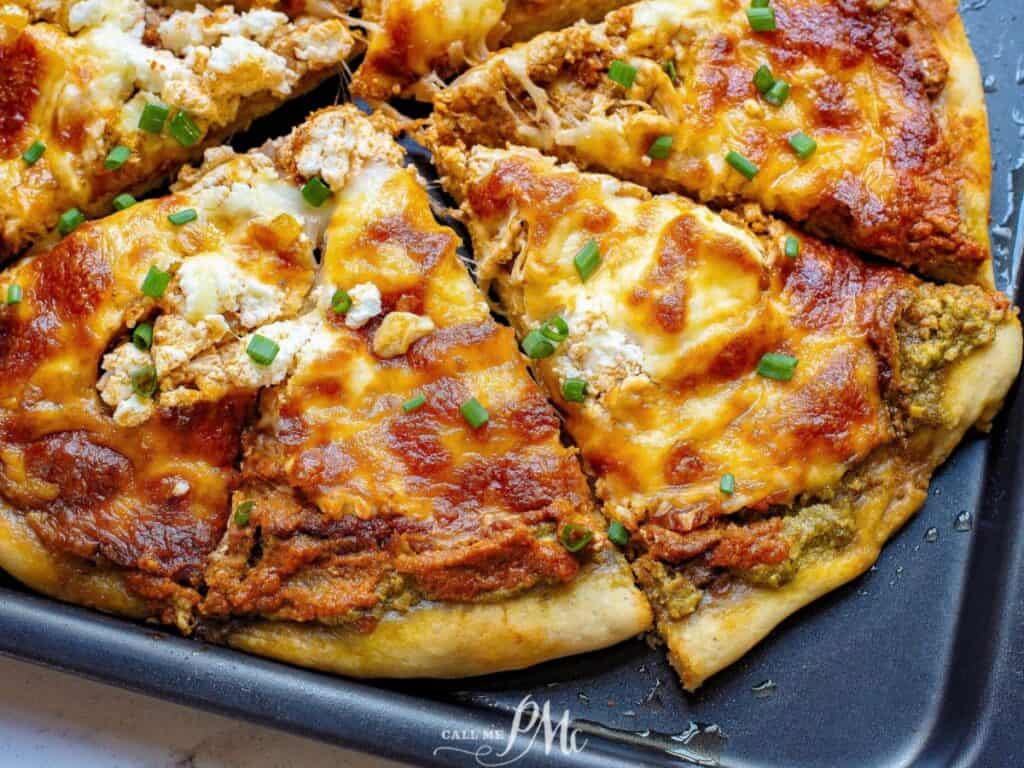 Image shows irresistible two pesto chicken pizza.