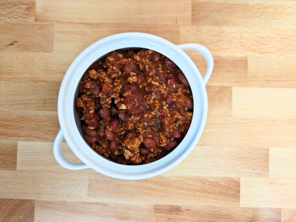Image shows overhead of cooked slow cooker pork chili.