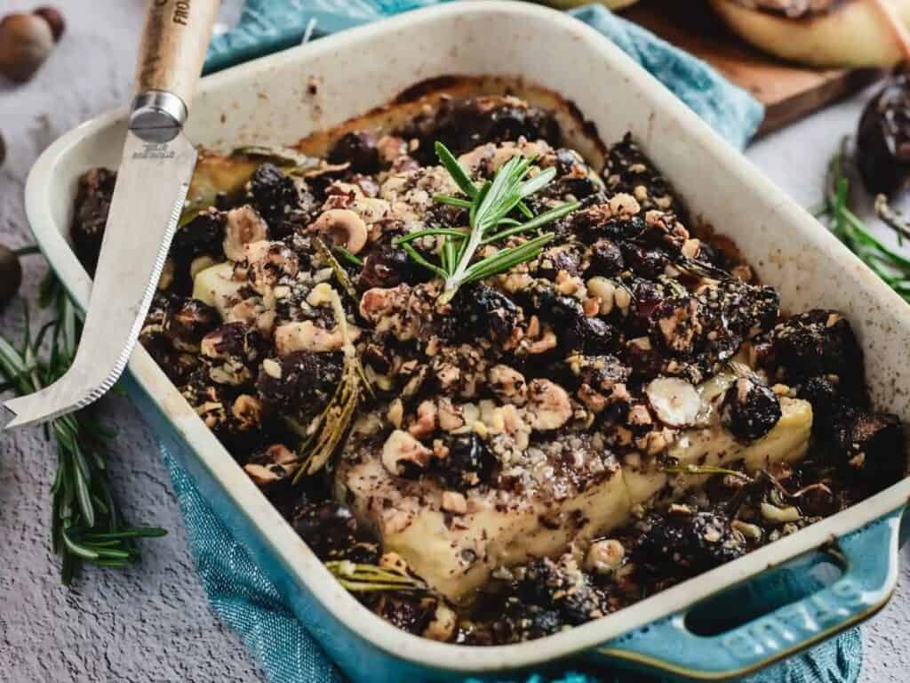 Image shows baked feta dip with honey, dates, and hazelnuts recipe.