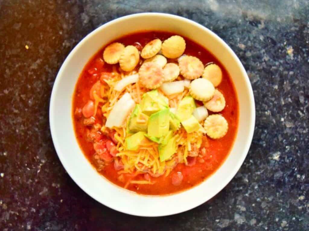 Image shows bowl of loaded and yummy crockpot chili.