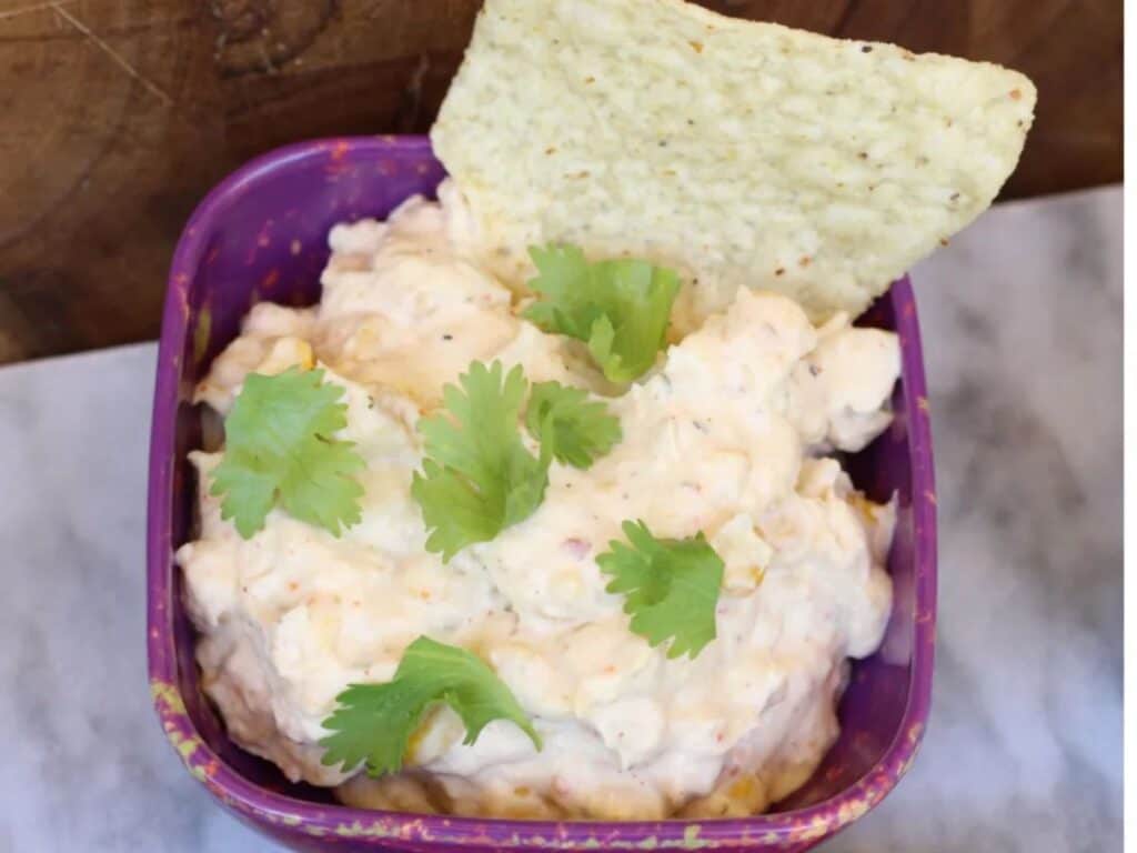 Image shows crockpot Mexican street corn salsa dip.
