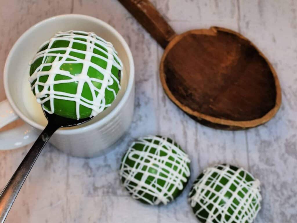 Image shows delicious St. Patrick's Day hot chocolate cocoa bombs.