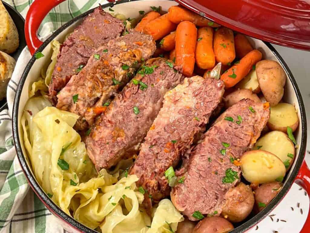 Image shows easy to make Dutch oven corned beef and cabbage.