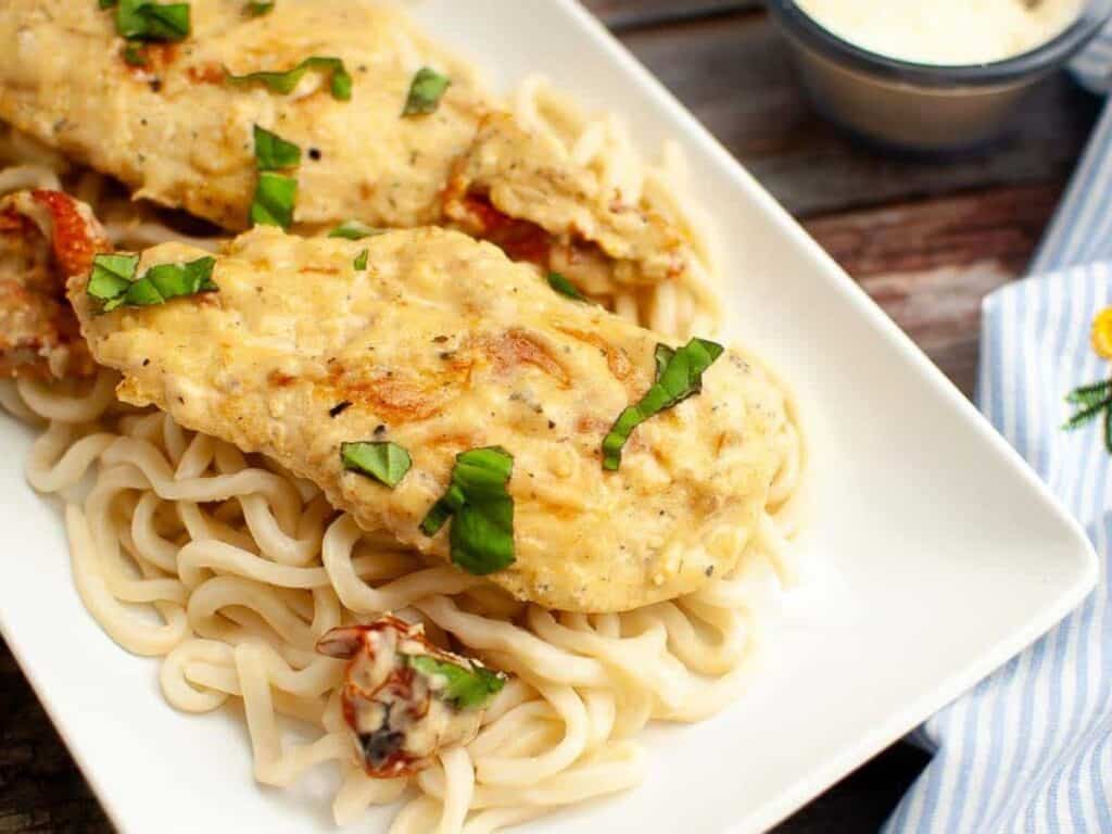 Image shows easy to make marry me chicken in the crockpot.