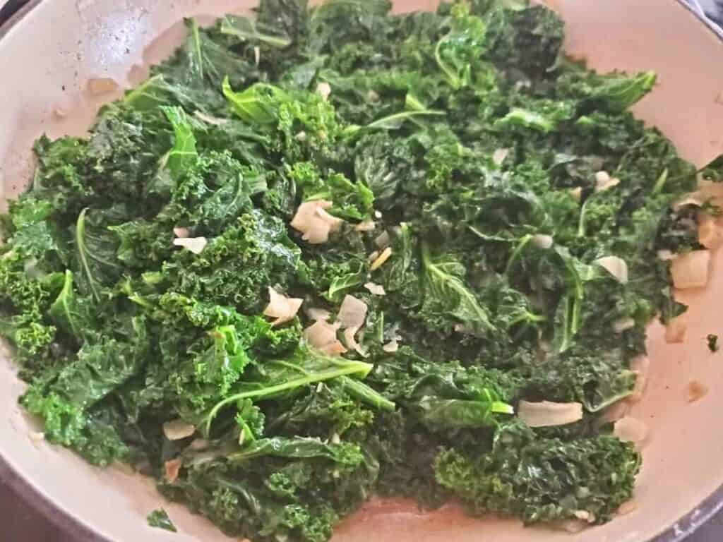 Image shows pot filled with yummy garlic sesame kale.