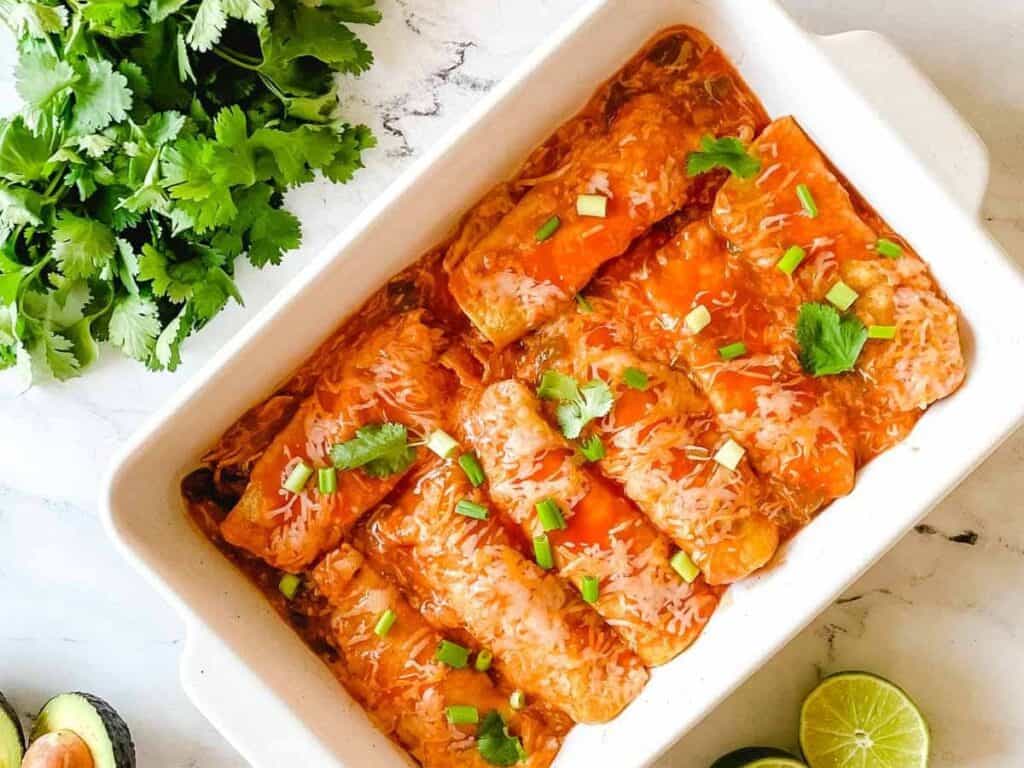 Image shows slow cooker chicken enchiladas recipe.