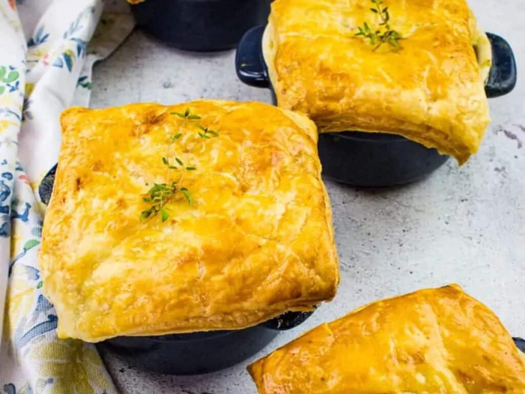 Image shows yummy turkey pot pies with puff pastry.