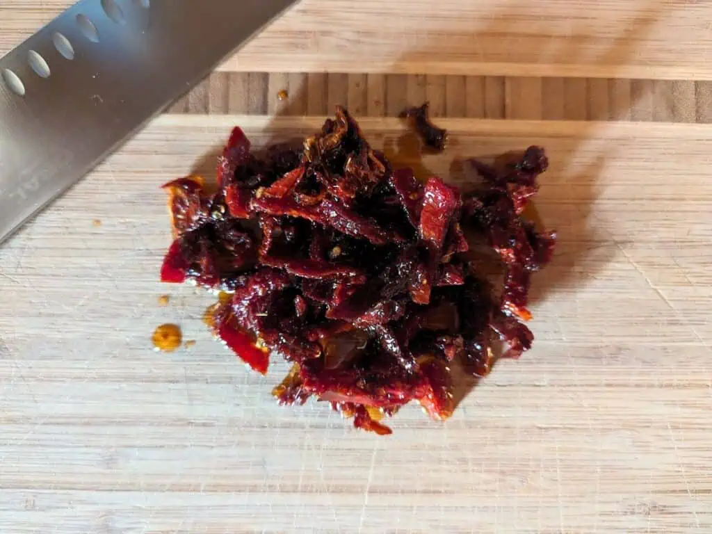 Image shows chopped sun-dried tomatoes.