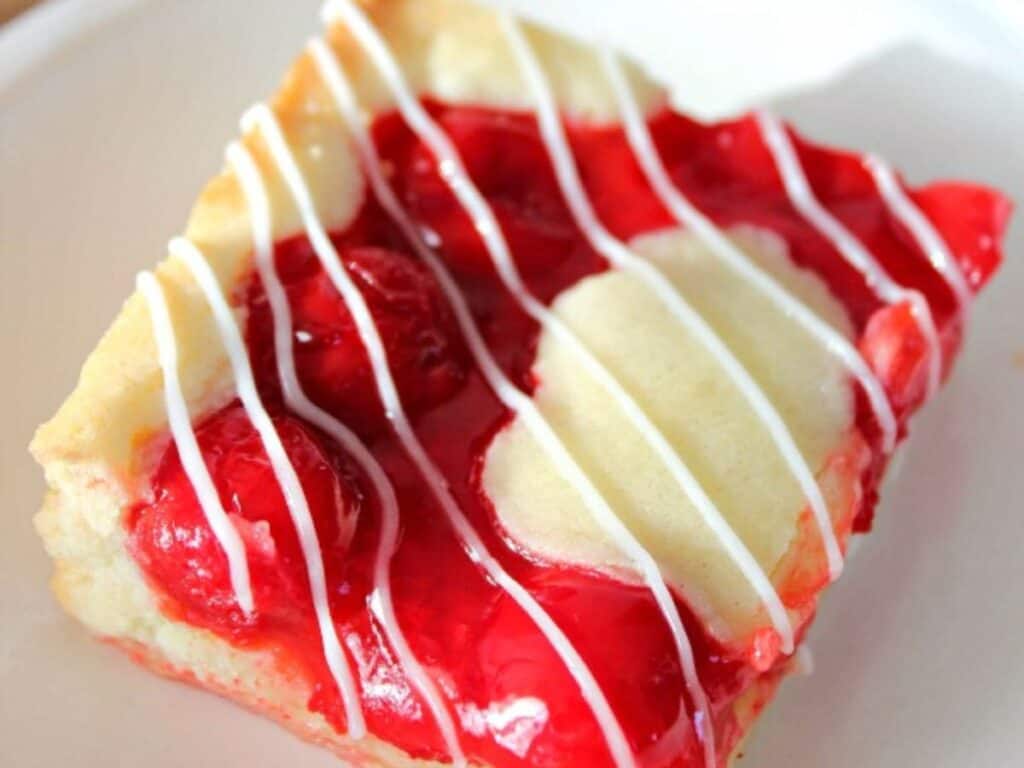 Image shows delicious cherry pie bars.