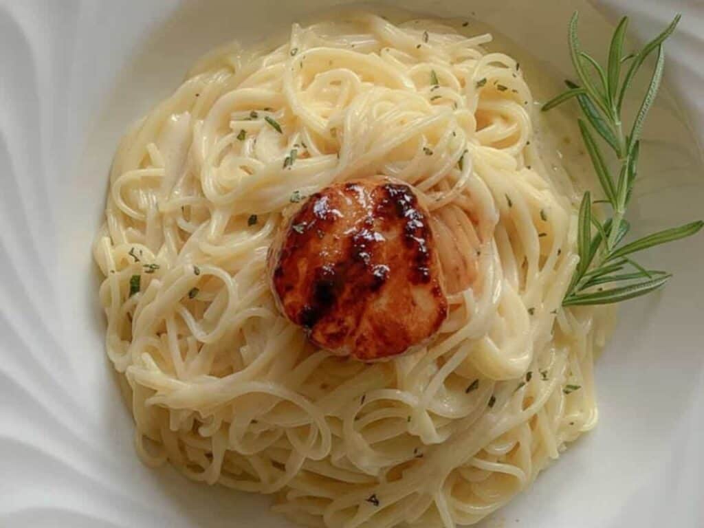 Image shows irresistible capellini beurre blanc with bronzed sea scallop.