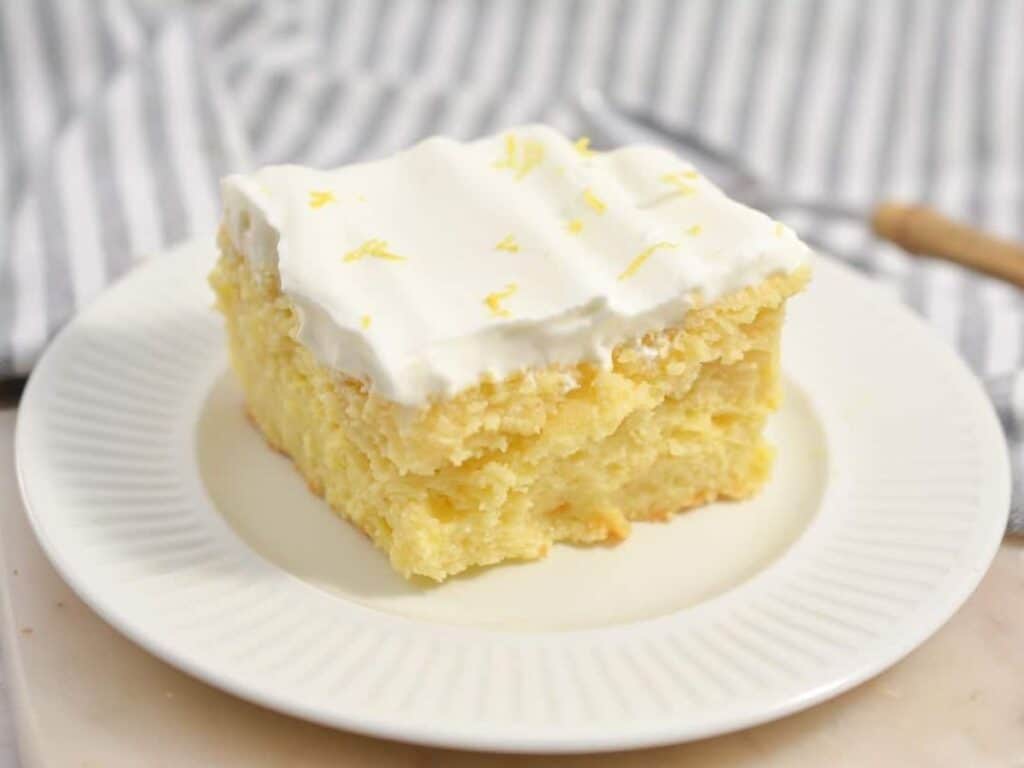 Image shows irresistible lemon poke cake.