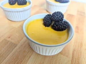 Image shows mango mousse in a ramekin.