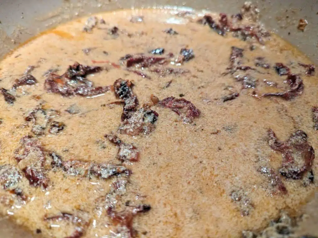 Image shows simmering the sauce for the salmon.