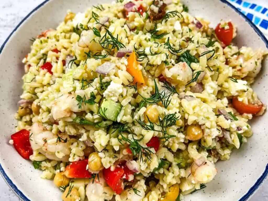 Image shows yummy Mediterranean orzo salad with shrimp.
