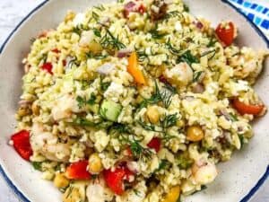 Image shows yummy Mediterranean orzo salad with shrimp.