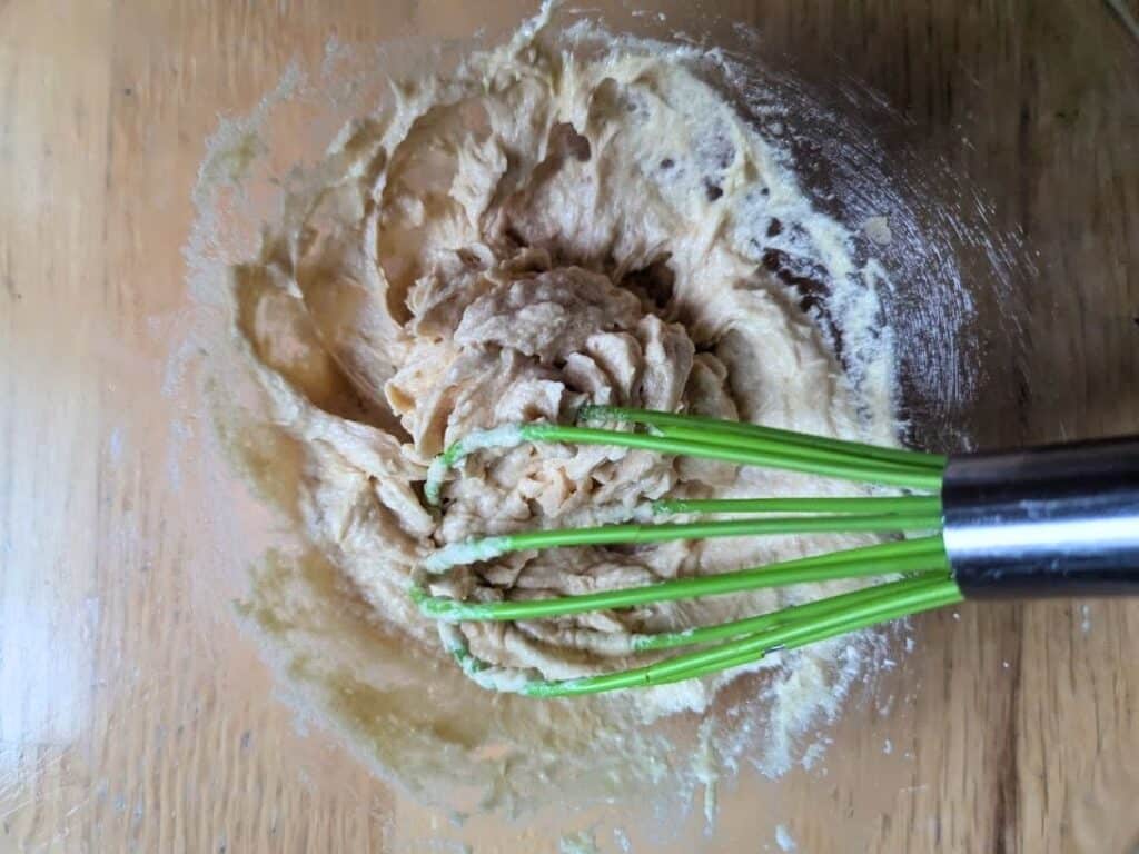 Image shows flour added to the bowl with other ingredients for individual chocolate chip skillet cookie.