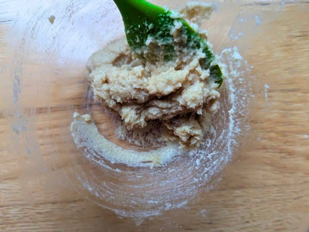 Image shows granulated sugar and brown sugar added to softened butter.