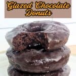 Image shows Stacked glazed chocolate donuts with text easy to make and decadent glazed chocolate donuts.