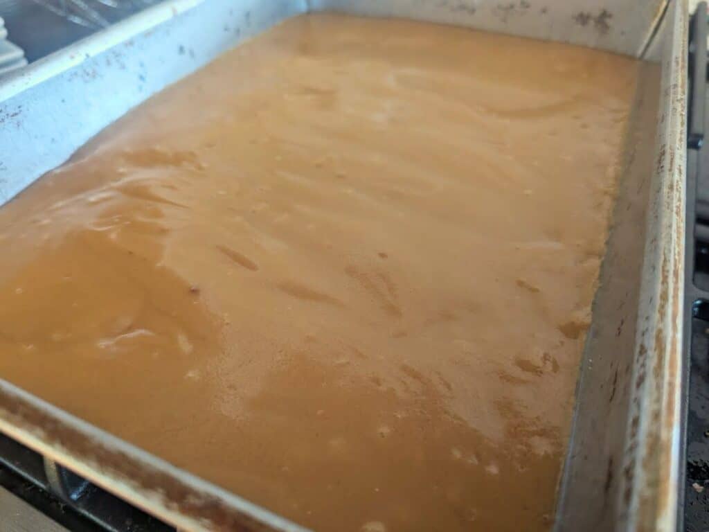 Image shows caramel filling spread over the shortbread base.