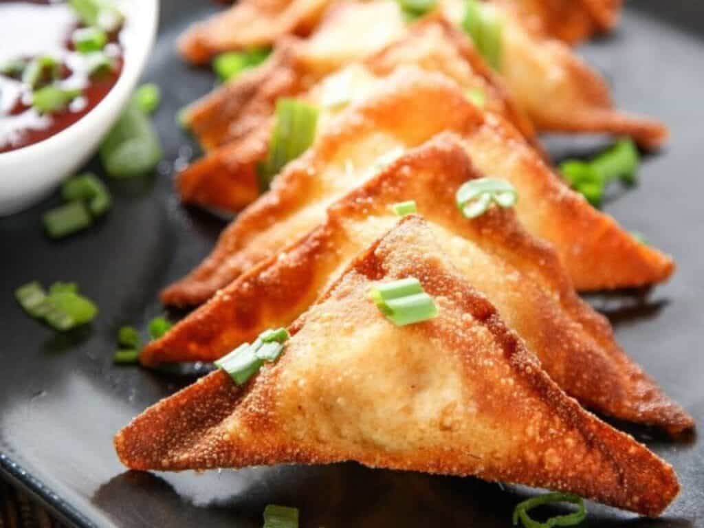 Image shows easy to make crab cream cheese wontons.